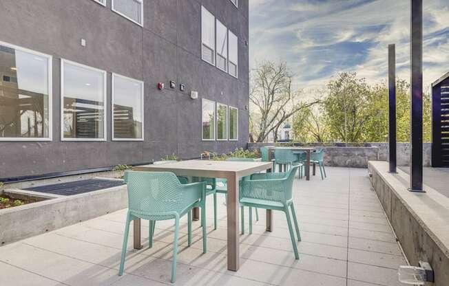 a patio with tables and chairs outside of a building