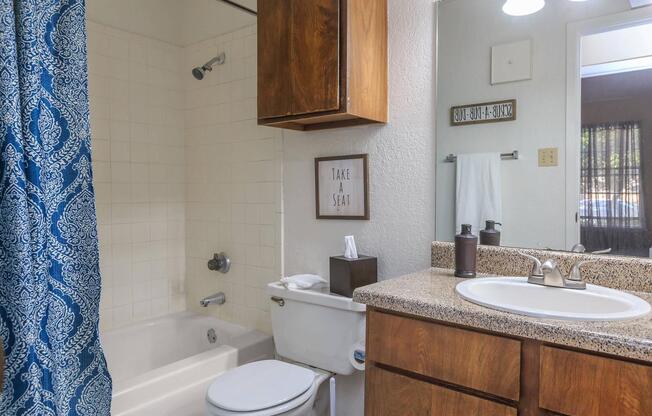 a large white tub next to a sink