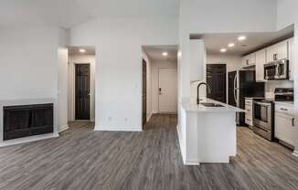 A modern kitchen with a white island and stainless steel appliances.