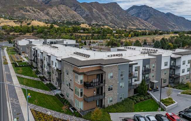 an aerial view of an apartment complex with mountains in the background