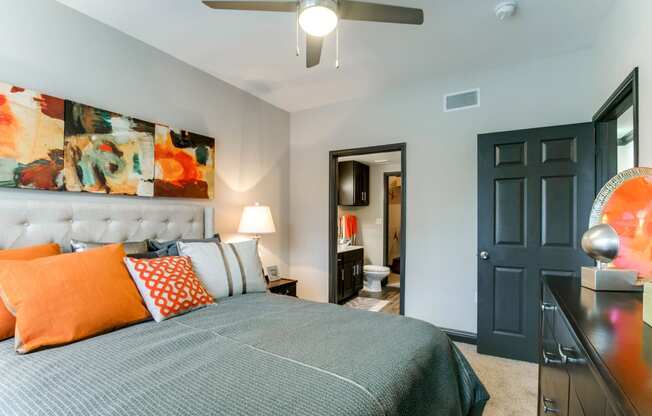 a bedroom with a bed and a ceiling fan