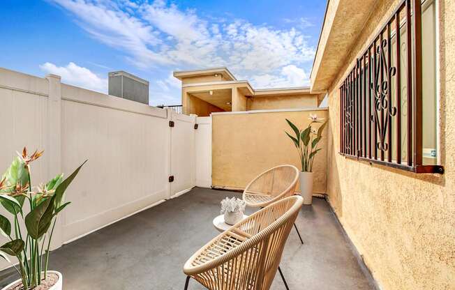 A patio with a chair and a table.