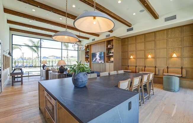 a large kitchen with a large island and a dining table  at Westbury Apartments, Rancho Cucamonga, CA