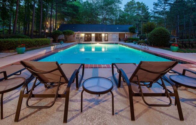 Webb Bridge Crossing Apartments in Alpharetta Georgia photo of a swimming pool at dusk with patio chairs