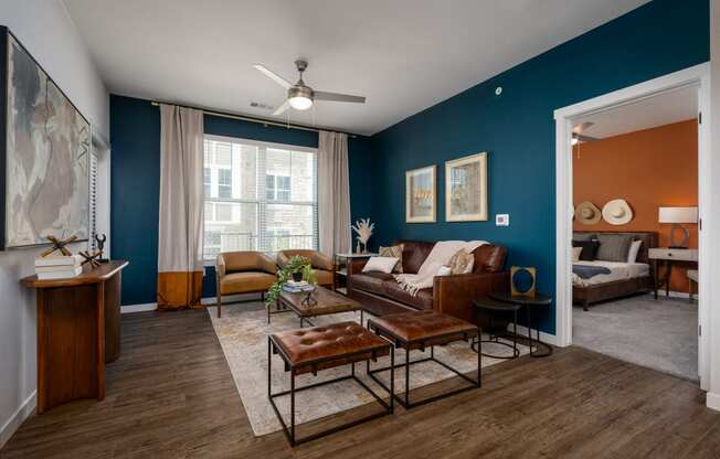 a living room with blue walls and brown furniture