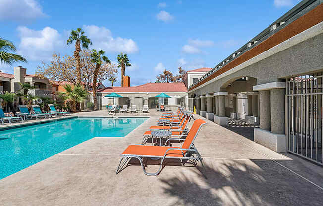 Community Swimming Pool with Pool Furniture at Stonegate Apartments located in Las Vegas, NV.