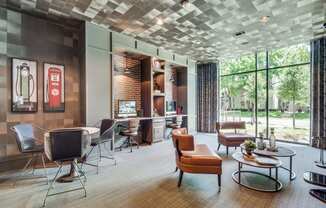 a room with chairs and tables and a large window