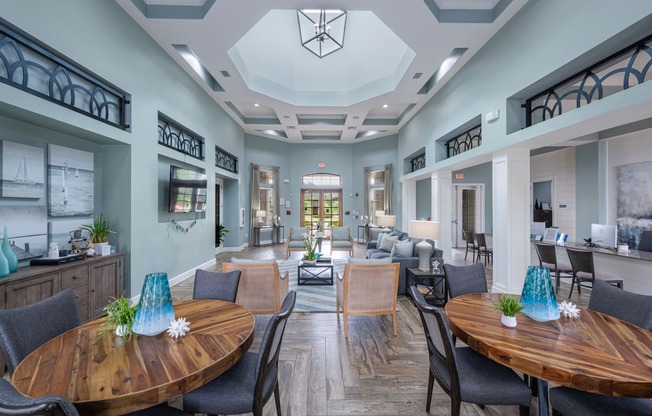 a dining room with tables and chairs and a living room