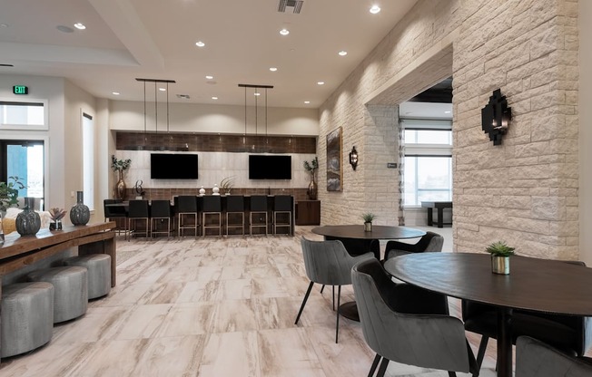 A modern dining room with a long table and chairs.
