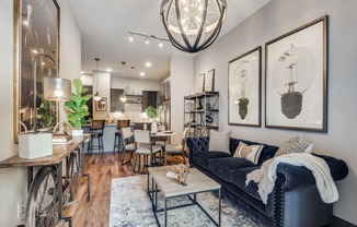 a living room filled with furniture and a large chandelier