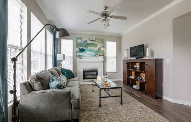 a living room with a couch and a ceiling fan