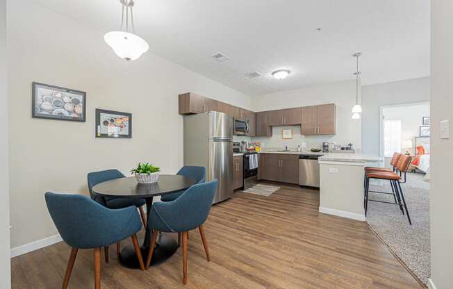 an open kitchen and dining area with a table and chairs