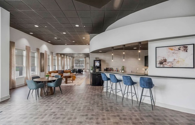 a large lobby with tables and chairs and a bar at CityView, North Kansas City, 64116