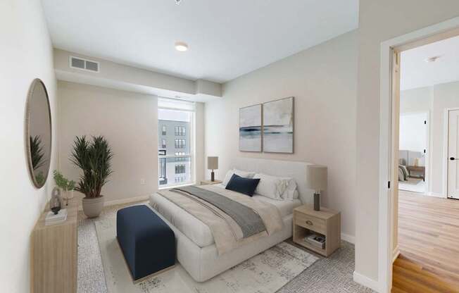 A bedroom with a large bed and a mirror on the wall.