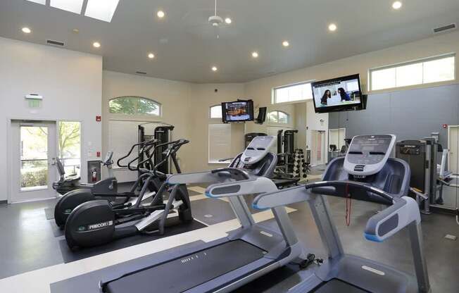 A gym with treadmills and exercise bikes at Wilsonville Summit Apartments, Oregon