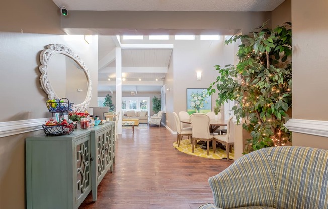A living room with a green cabinet, a mirror, and a couch.