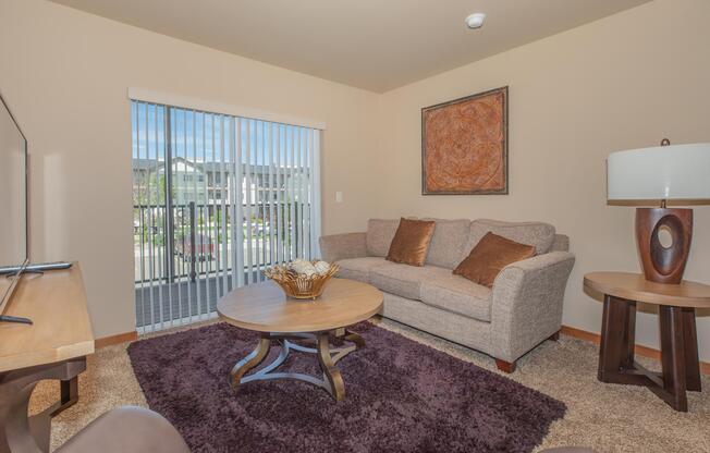 a living room filled with furniture and a large window