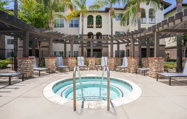 A pool with a fountain in the middle of it.