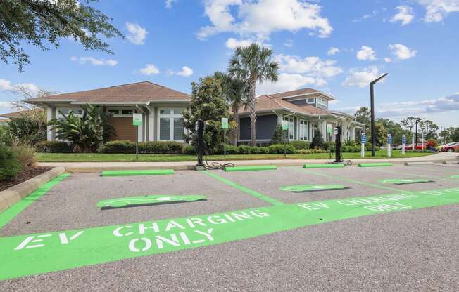 a home with a parking lot with electric charging only