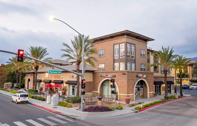 A street view of a building with a red traffic light.