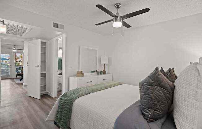 A bedroom with a bed, dresser, and mirror.