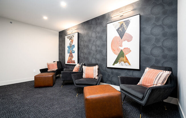 a waiting room with chairs and paintings on the wall