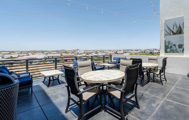 tables and chairs on a rooftop patio with a view of scottsdale arizona
