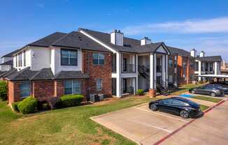 an apartment building with cars parked in front of it