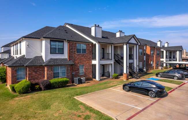 an apartment building with cars parked in front of it