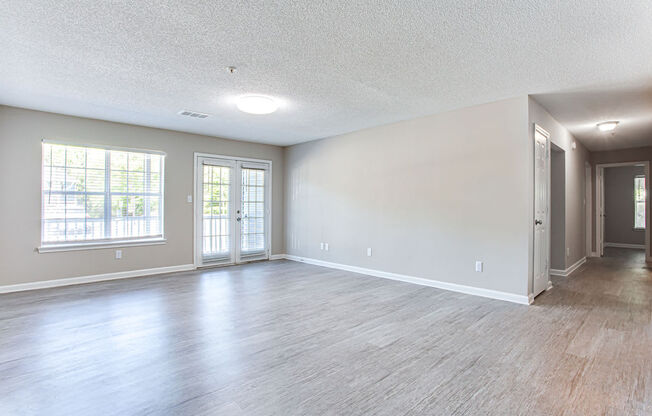 an empty living room with hardwood floors