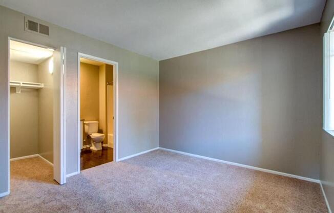 an empty room with a toilet and a closet