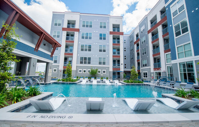a swimming pool in front of an apartment building