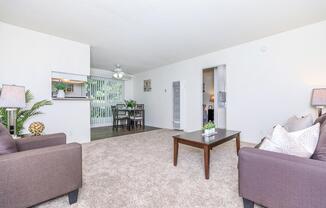 a living room filled with furniture and a flat screen tv