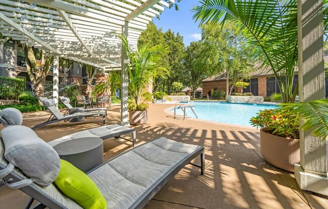 A sunny day at the poolside with a white canopy overhead.