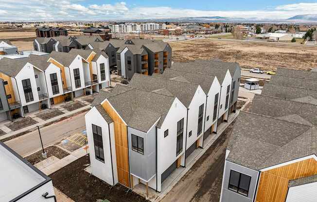 A row of houses with grey roofs and wooden accents.