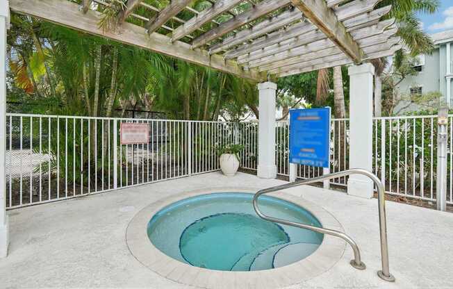A small pool with a white fence around it.