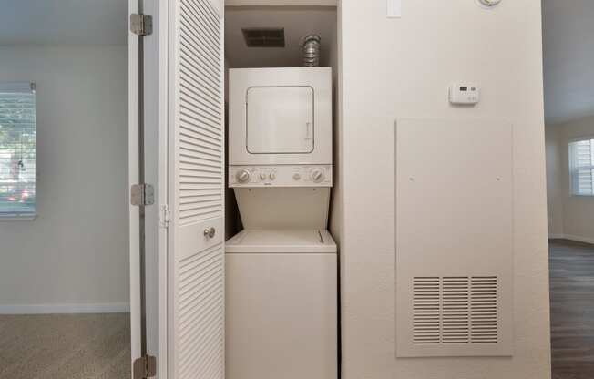 an empty laundry room with a washer and dryer in it at Rush River Apartments, Sacramento