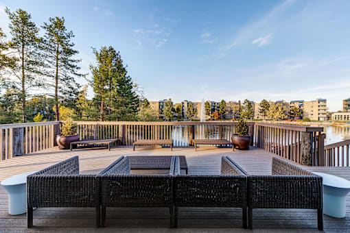 a deck with a fire pit and a view of the city at Ashford Belmar Apartments, Colorado