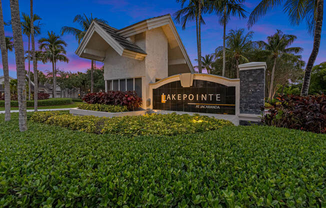 a building with a sign that reads lake pointe in front of palm trees