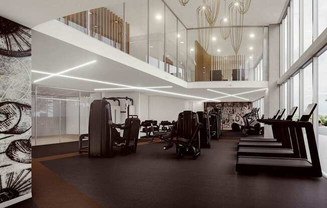A gym with treadmills, elliptical machines, and other exercise equipment.