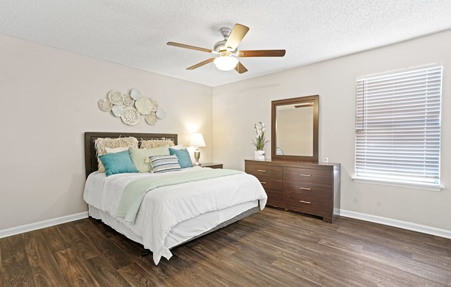 a bedroom with a bed and a ceiling fan