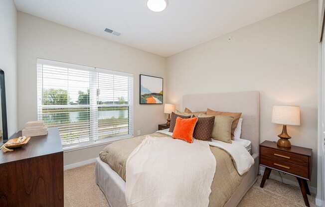 a bedroom with a large bed and a window