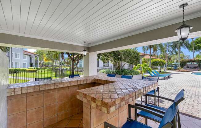 A patio with a table and chairs under a roof.