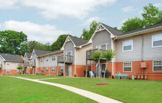 a row of houses with a grassy yard