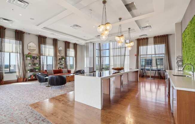 a large room with a kitchen and a large window