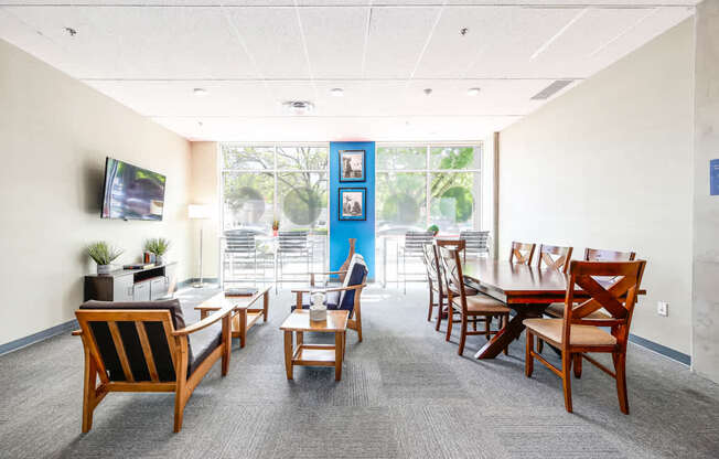 A conference room with a long table and chairs.