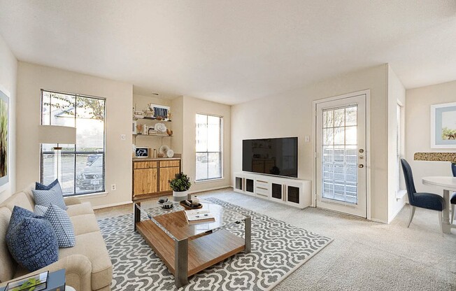 Welcome to Elm Creek Apartments, where modern living meets comfort. This stunning living area features natural light, stylish decor, and an inviting atmosphere perfect for relaxation. Explore your new home today and schedule a tour!
