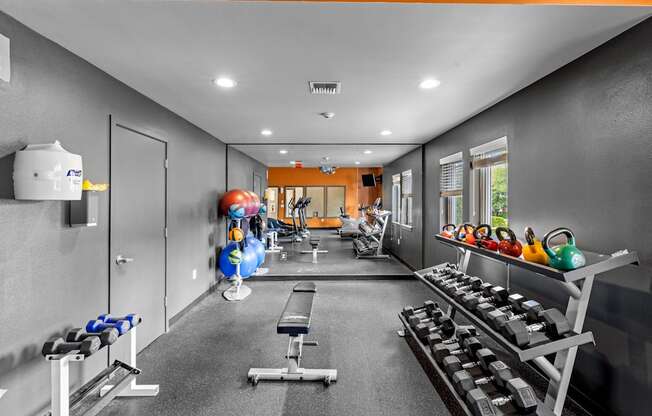 a workout room with weights and other exercise equipment