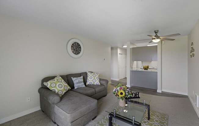 a living room with a couch and coffee table at Campo Basso Apartment Homes, Lynnwood, WA