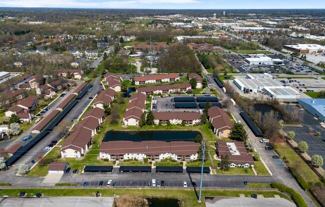 an aerial view of a neighbourhood of houses and a parking lot
